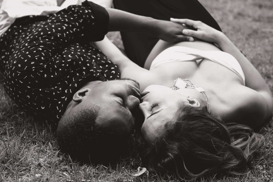 couple lying on the grass