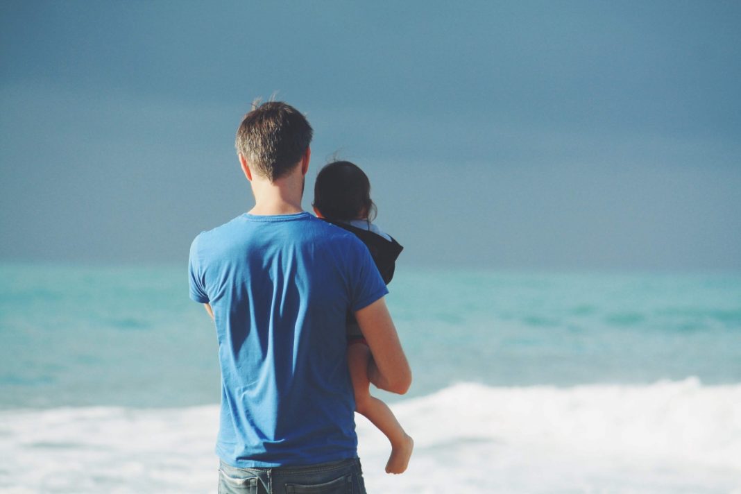 Father with child at the sea
